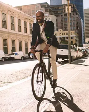 Man in sport coat riding a bicycle